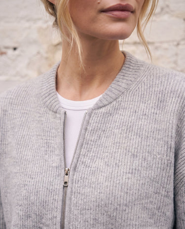 The Molly ribbed zip-up cardigan in gray — close-up of the round neck and front zip