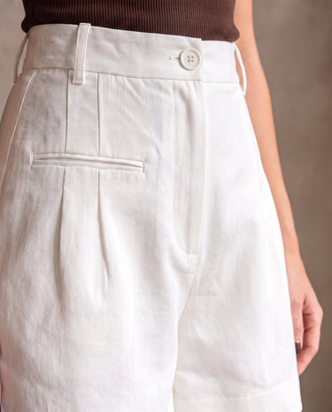 The Monroe short in white — close-up of the high waist and front pleats