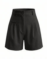The Monroe short in black — high-waisted pleated wide-leg shorts, product flat-lay