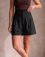 The Monroe short in black — front view with hand on hip on model