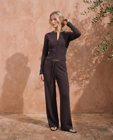 The Moriel Knit Ribbed Matching Set in chocolate — ribbed knit set with wide-leg trousers, side view on model