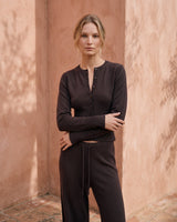 The Moriel Knit Ribbed Matching Set in chocolate — ribbed knit cardigan and trousers, three-quarter view on model