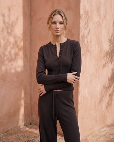 The Moriel Knit Ribbed Matching Set in chocolate — ribbed knit cardigan and trousers, three-quarter view on model