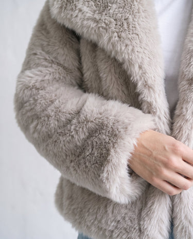 The Noa Faux Fur Coat in beige — close-up of sleeve and fur texture