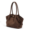 The Odette Suede Tote in brown, three-quarter view showing the winged side pocket and gold-tone keeper