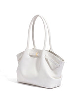 The Odette Tote in white pebbled leather, three-quarter studio view on a pure white background with gold-tone keeper