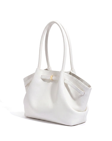 The Odette Tote in white pebbled leather, three-quarter studio view on a pure white background with gold-tone keeper