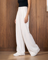 The Oriane pants in white — side view on model