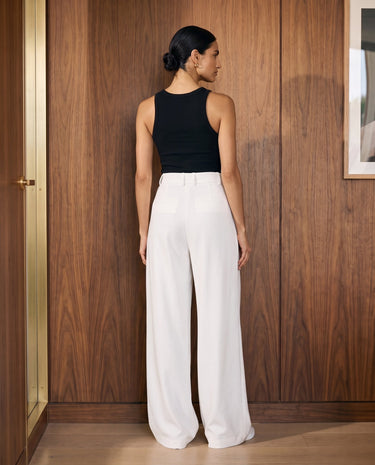 The Oriane pants in white — back view on model