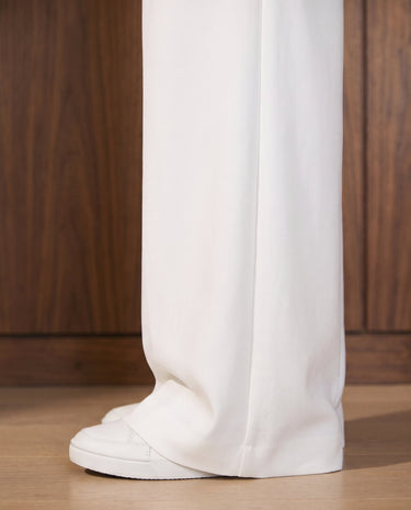 The Oriane pants in white — close-up of the wide-leg hem