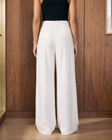 The Oriane pants in white — back view on model