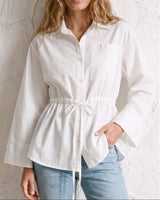 The Palma Cotton Button Up in white — collared cotton shirt with tie waist, front view on model
