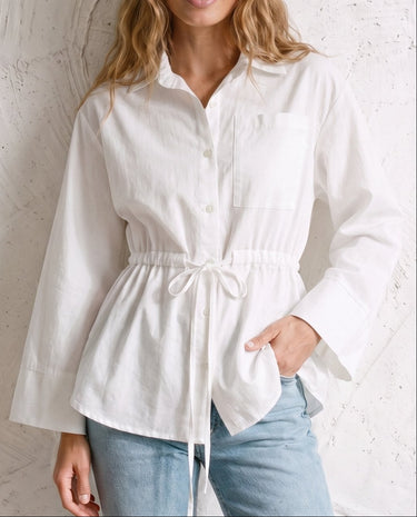 The Palma Cotton Button Up in white — collared cotton shirt with tie waist, front view on model