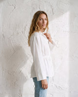 The Palma Cotton Button Up in white — cotton shirt, side view on model