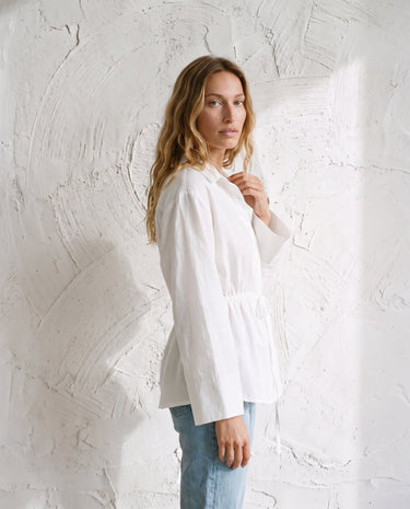The Palma Cotton Button Up in white — cotton shirt, side view on model