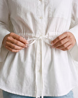 The Palma Cotton Button Up in white — close-up of drawstring waist tie