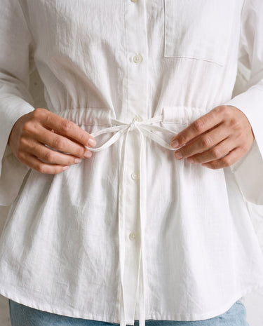 The Palma Cotton Button Up in white — close-up of drawstring waist tie