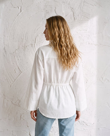 The Palma Cotton Button Up in white — collared cotton shirt, back view on model