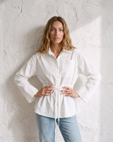 The Palma Cotton Button Up in white — cotton shirt with cinched tie waist, front view on model