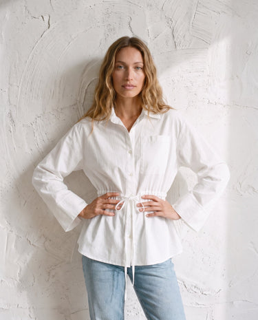 The Palma Cotton Button Up in white — cotton shirt with cinched tie waist, front view on model
