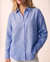 Model wearing the blue poplin shirt with white trousers, close front view – Moriel Heritage