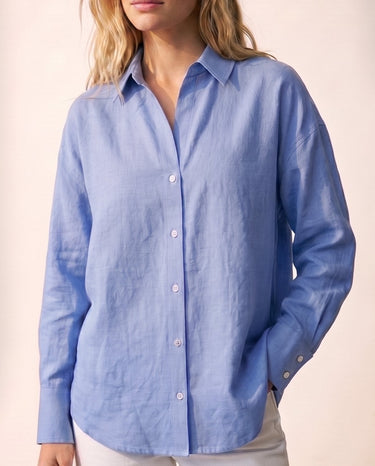 Model wearing the blue poplin shirt with white trousers, close front view – Moriel Heritage