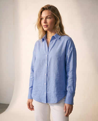 Model wearing the blue poplin shirt with white trousers, front view – Moriel Heritage