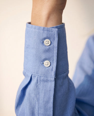 Close-up of the blue shirt's buttoned cuff – Moriel Heritage