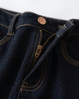 Close-up of dark denim Rhys Jeans showing zip fly, copper button and contrast topstitching – Moriel Heritage
