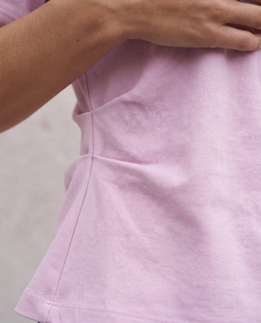 The Riela Tee in pink — close-up of the side waist pleat detail