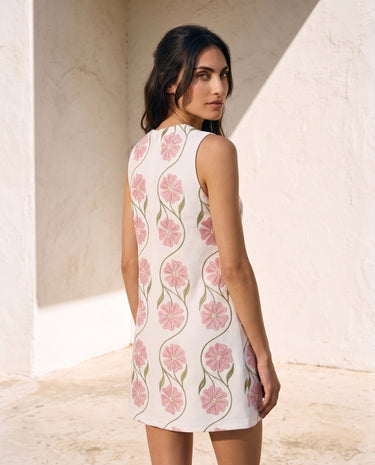 The Rosalie Floral Dress in pink — sleeveless floral mini dress, back view on model