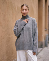 The Ruby sweater in stone — front view on model