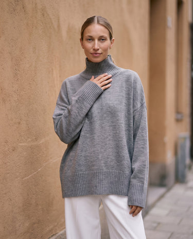 The Ruby sweater in stone — front view on model