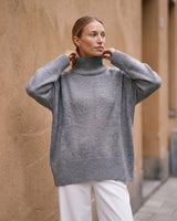 The Ruby sweater in stone — front view on model
