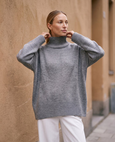 The Ruby sweater in stone — front view on model