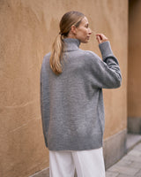 The Ruby sweater in stone — back view on model