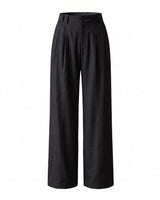The Sabine tailored trousers in black — high-waisted wide-leg pleated trousers, product flat-lay