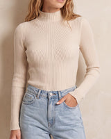 The Sable mock neck top in beige — front view on model