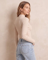 The Sable mock neck top in beige — side view on model