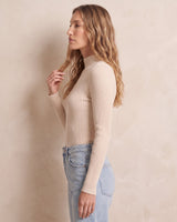 The Sable mock neck top in beige — front view on model