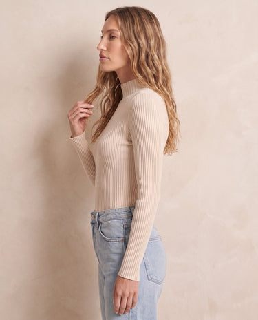 The Sable mock neck top in beige — front view on model