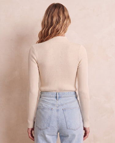 The Sable mock neck top in beige — back view on model