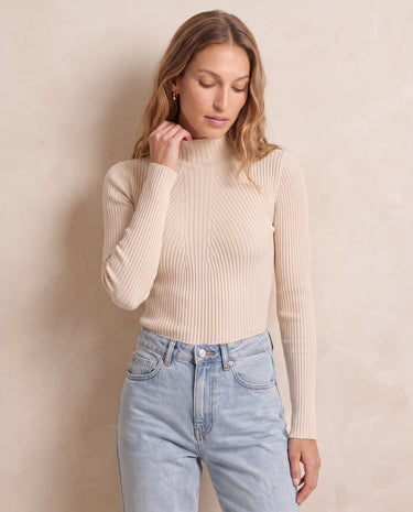 The Sable mock neck top in beige — front view on model