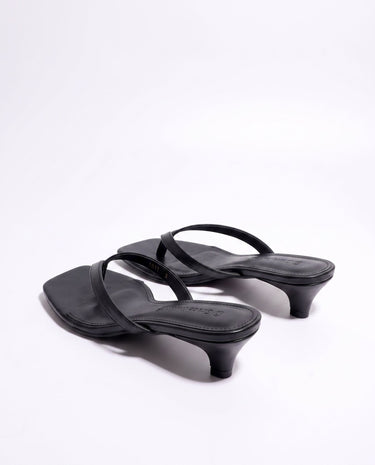 The Saskia thong sandal in black, kitten-heel style — back three-quarter view