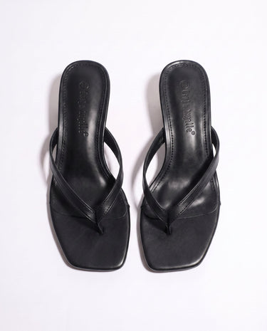 The Saskia thong sandal in black, kitten-heel style — top-down view of the pair