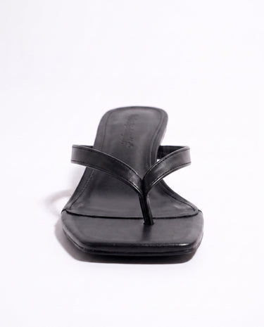 The Saskia thong sandal in black, kitten-heel style — side view of the toe strap