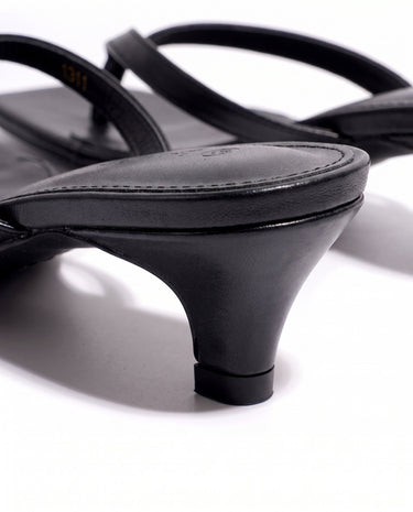 The Saskia thong sandal in black, kitten-heel style — close-up of the kitten heel