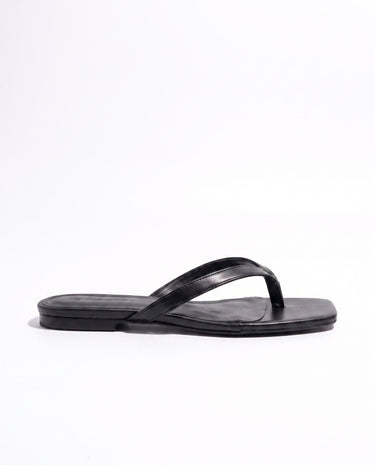 The Saskia thong sandal in black, flat style — slim-strap flat thong sandal, product photo