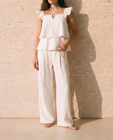 The Seraphine Cotton Set in white — flutter-sleeve top and wide-leg trousers, front view on model