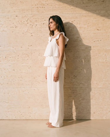 The Seraphine Cotton Set in white — two-piece set with tiered ruffle top, side view on model